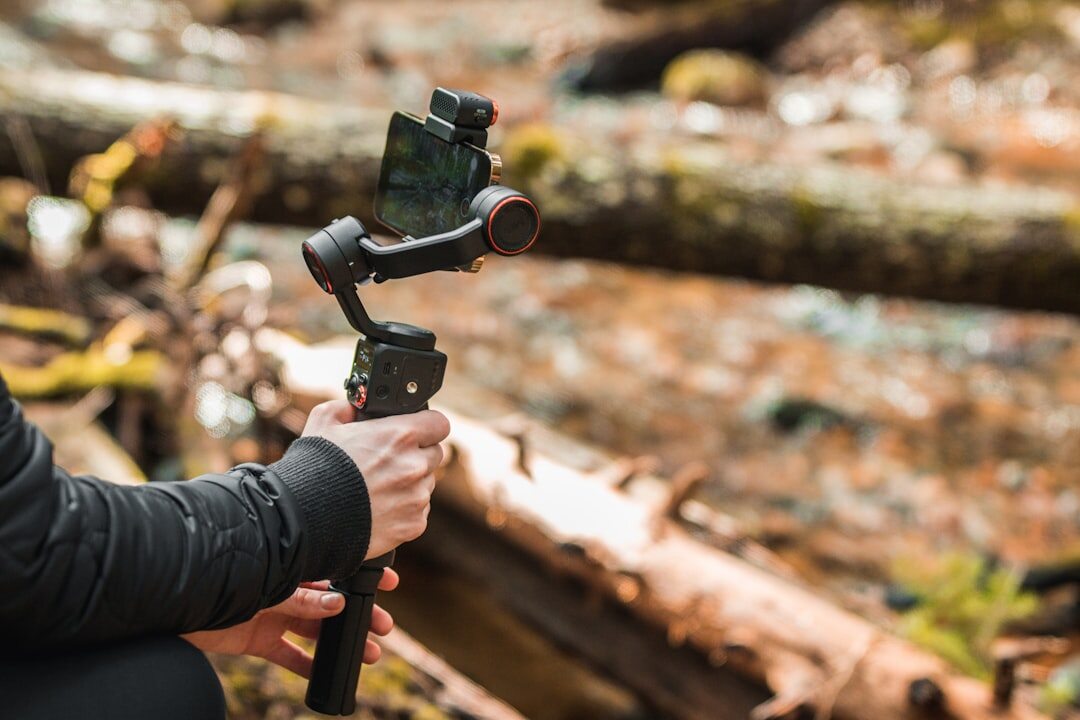 Content creator filming a vertical video with a smartphone on a gimbal