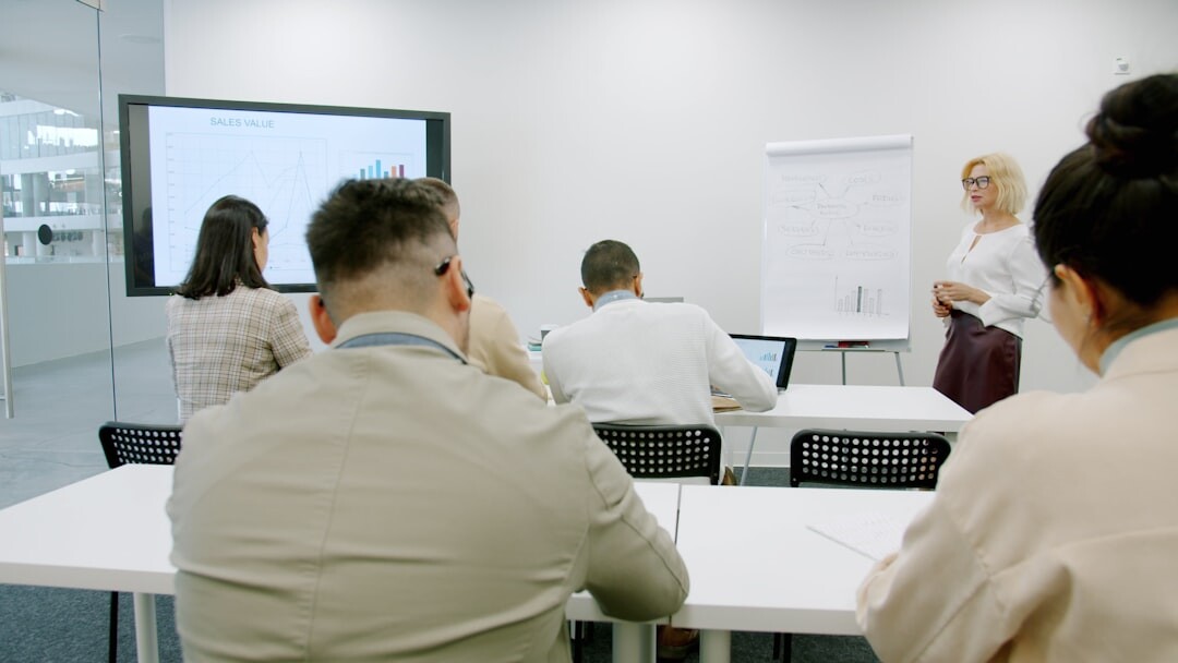 Group of trainees learning video production in a bright classroom