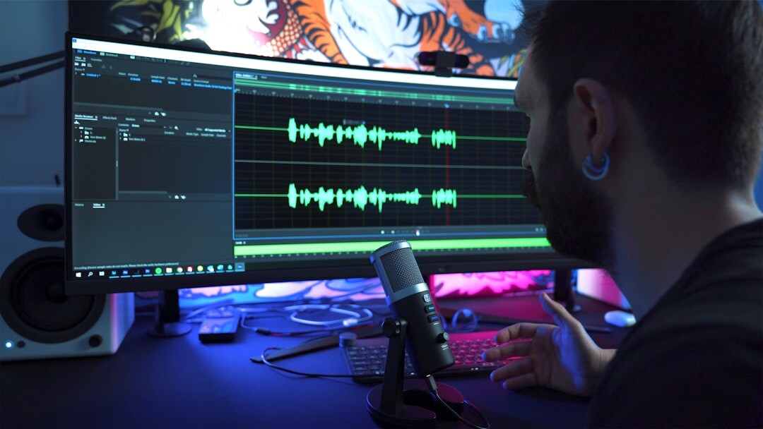 Video editor working on a multi-screen editing timeline in a studio