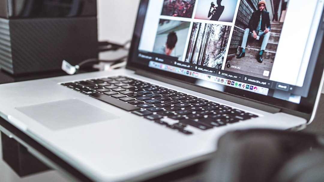Person arranging storyboard cards next to a laptop with video editing software