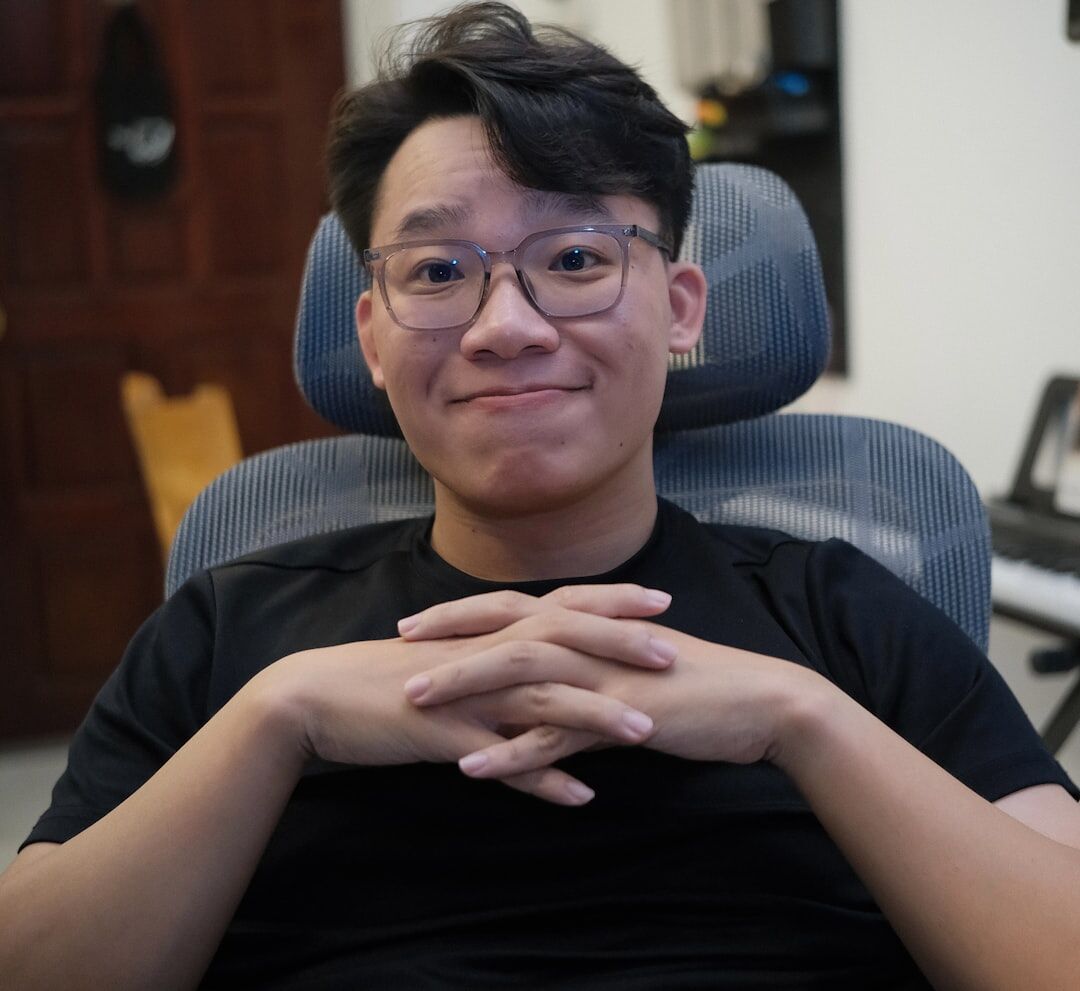 Studio portrait of a man video editor and trainer with glasses