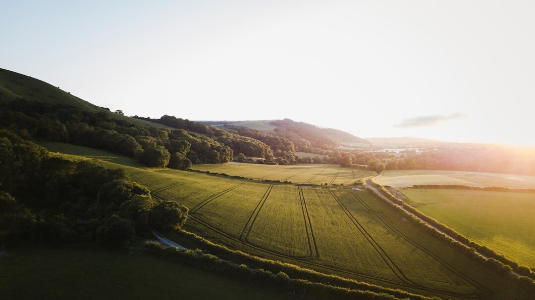 Drone operator filming an aerial sequence in the countryside